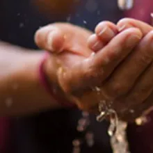 woman's hands with water flowing over them